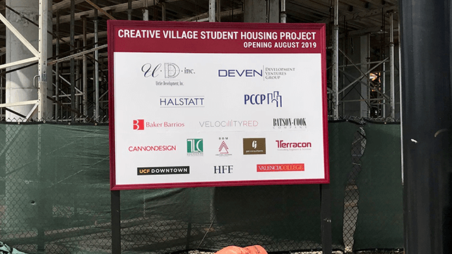 Construction site sign with contributing businesses and logos